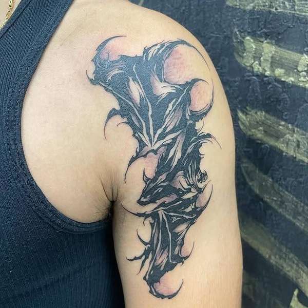 Abstract blackwork tattoo on upper arm