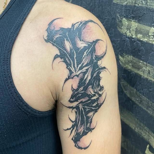Abstract blackwork tattoo on upper arm