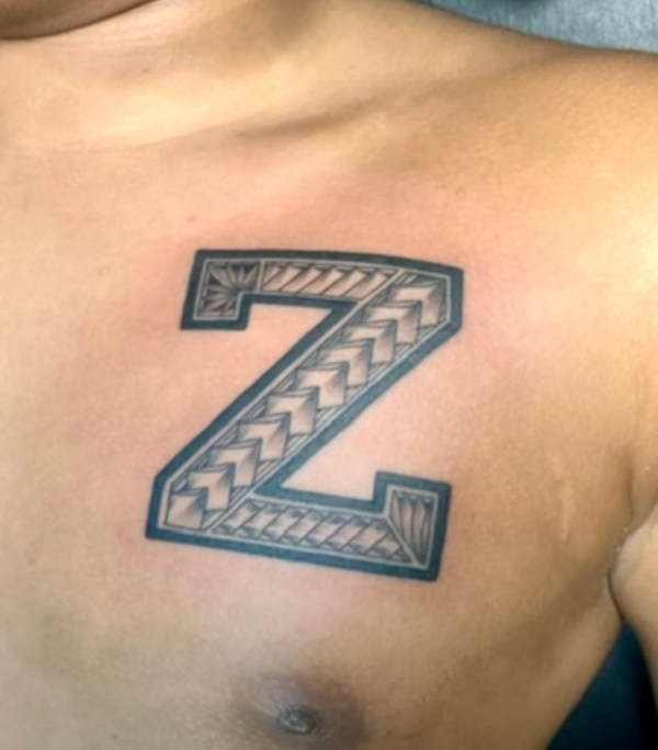 Black and grey geometric letter Z tattoo on chest