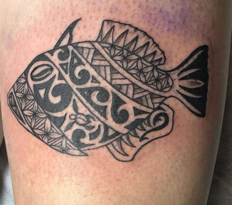 Blackwork tribal fish tattoo on thigh