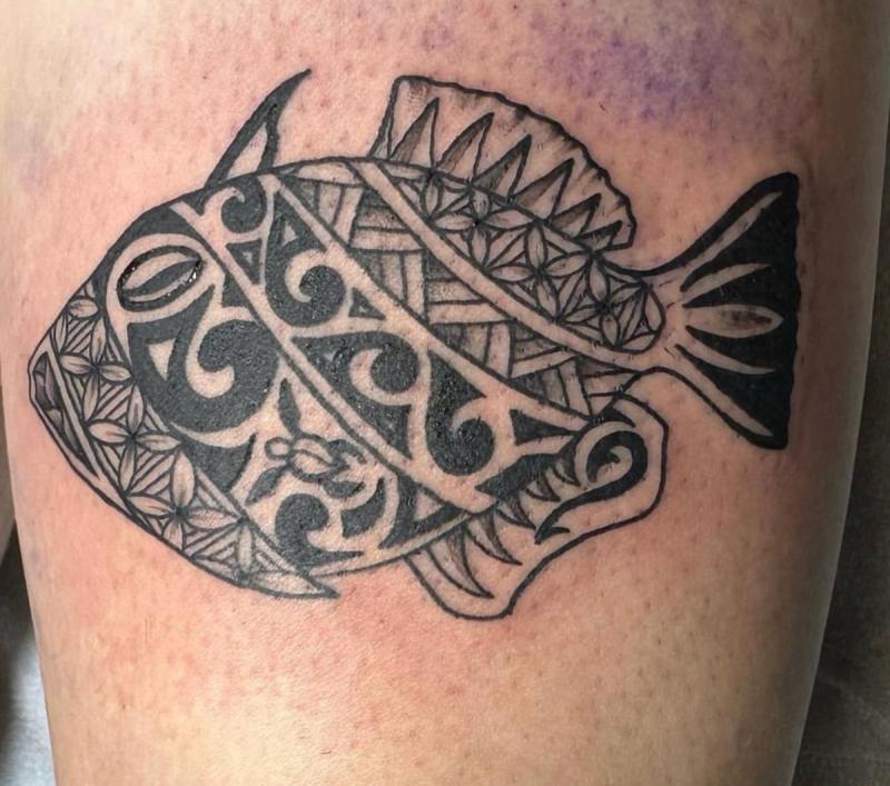 Blackwork tribal fish tattoo on thigh