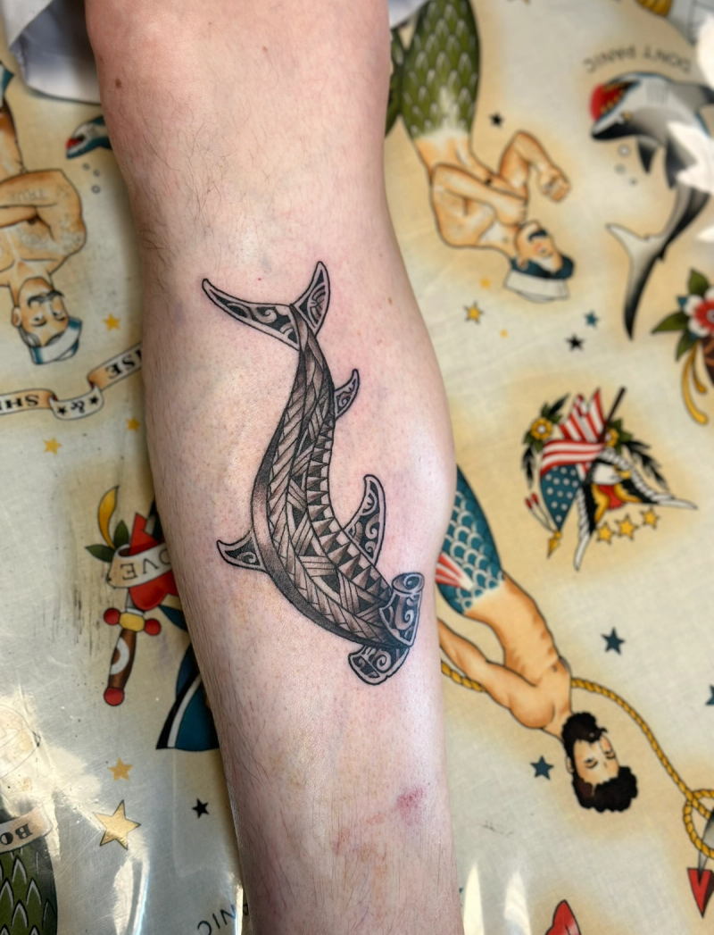 Black and grey tribal shark tattoo on calf