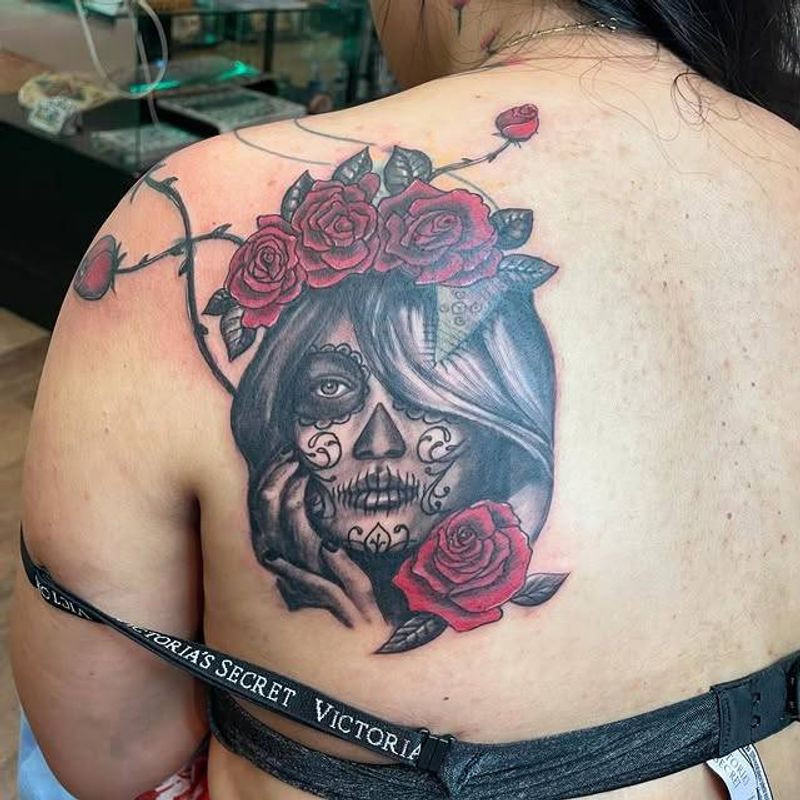 Illustrative sugar skull woman with roses on upper back