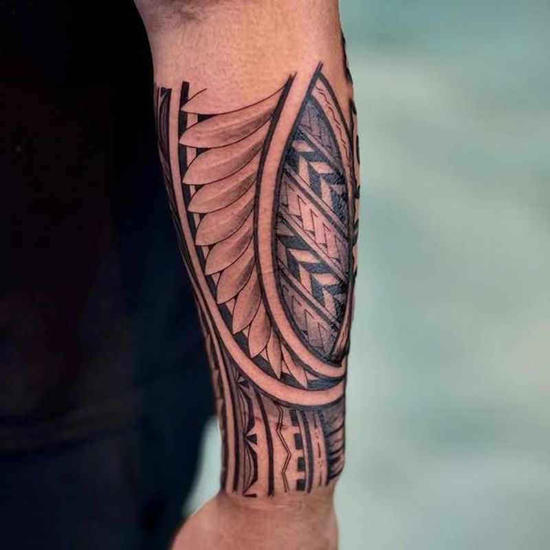 Blackwork tribal geometric tattoo on forearm