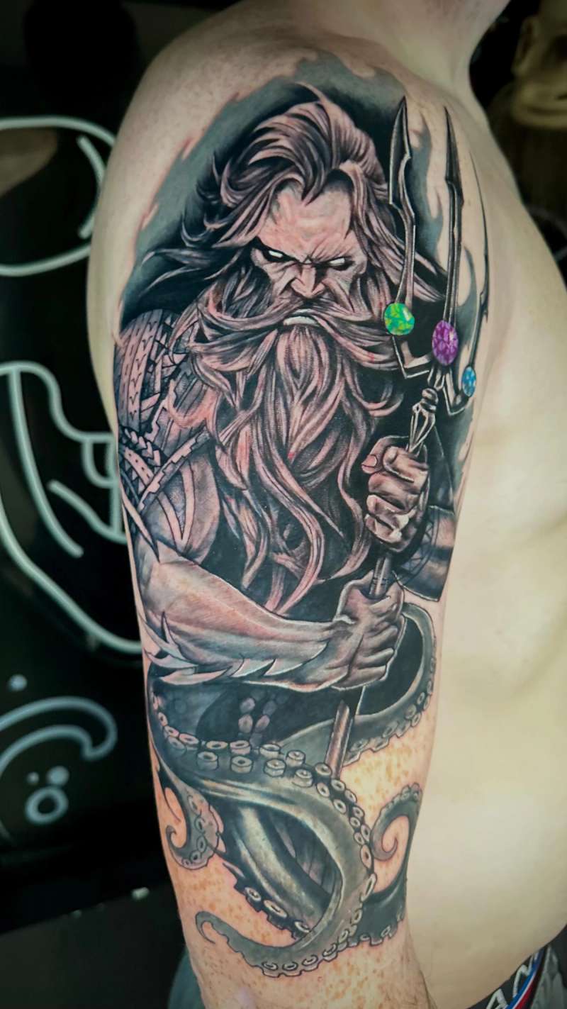 black and grey illustrative tattoo on upper arm
