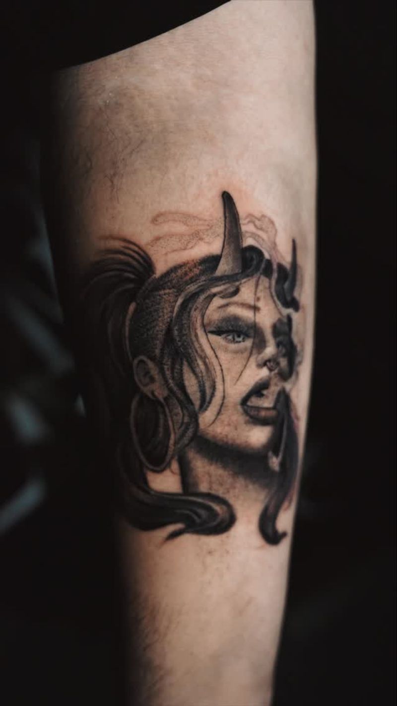 Black and grey realistic demon woman tattoo on forearm