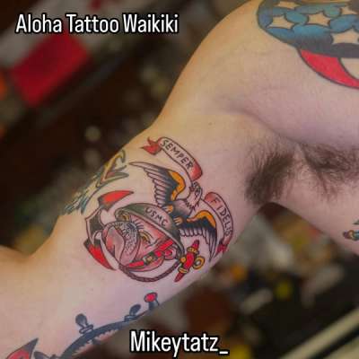 traditional american usmc eagle globe and anchor tattoo on upper arm with semper fidelis banner