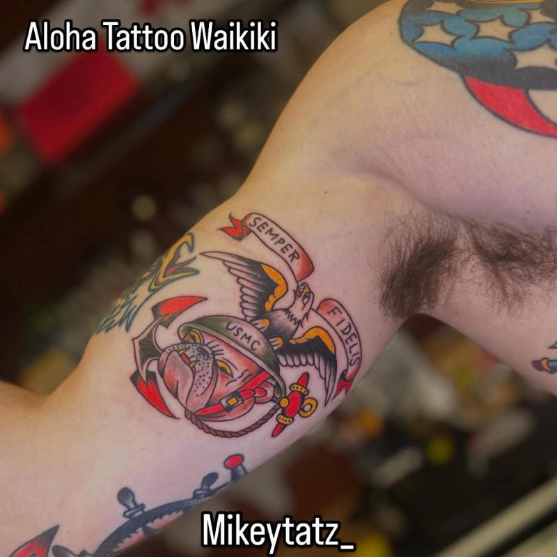 traditional american usmc eagle globe and anchor tattoo on upper arm with semper fidelis banner