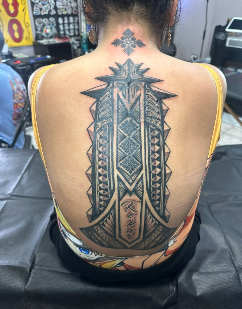 Black and grey large tribal geometric design on upper back
