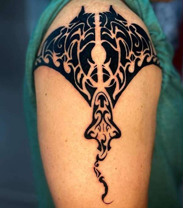 tribal style manta ray tattoo on upper arm