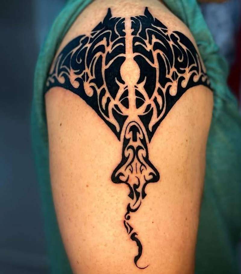 tribal style manta ray tattoo on upper arm