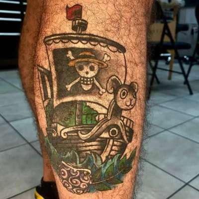 illustrative pirate ship tattoo on the calf