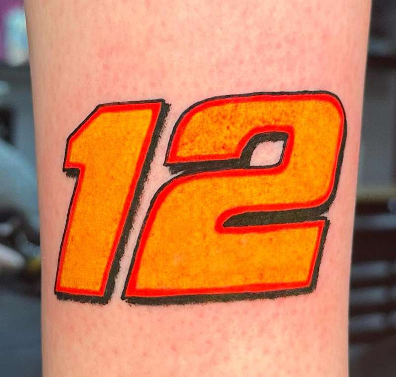 colorful number 12 tattoo on upper arm