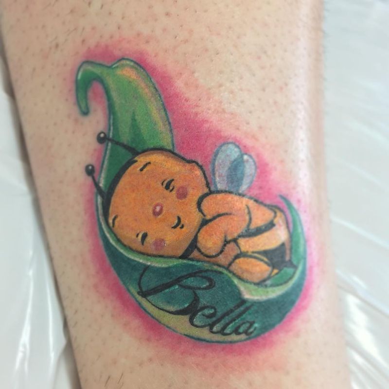 colorful bee in leaf tattoo with lettering on calf