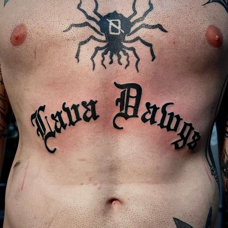 black script tattoo on upper torso