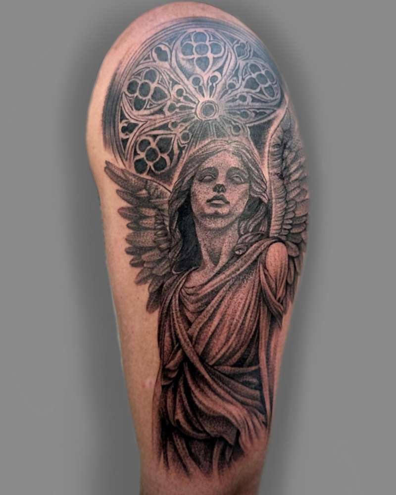 Black and grey realistic angel tattoo on upper arm