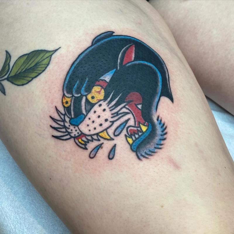 traditional panther tattoo on thigh in color