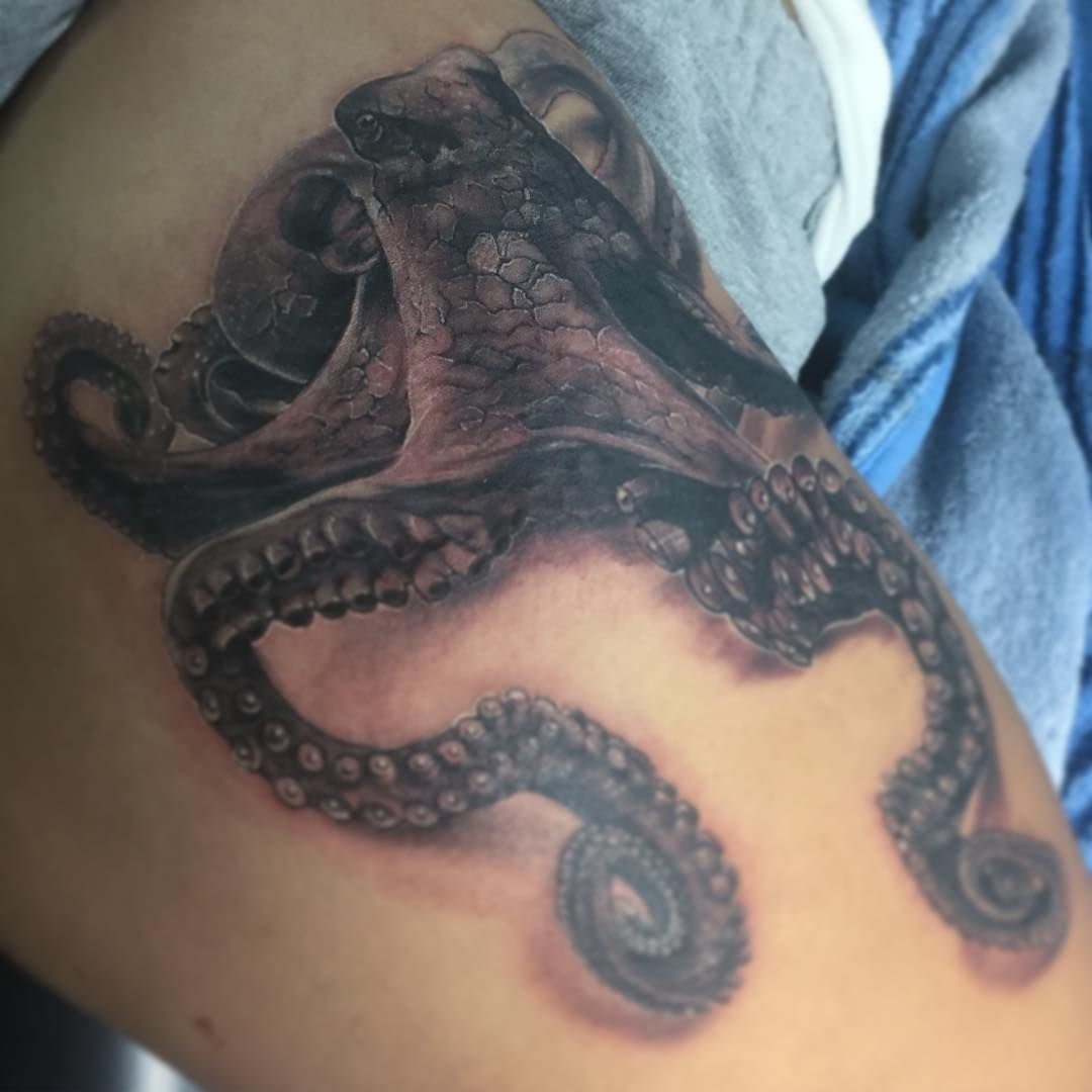Black and grey realistic octopus tattoo on thigh