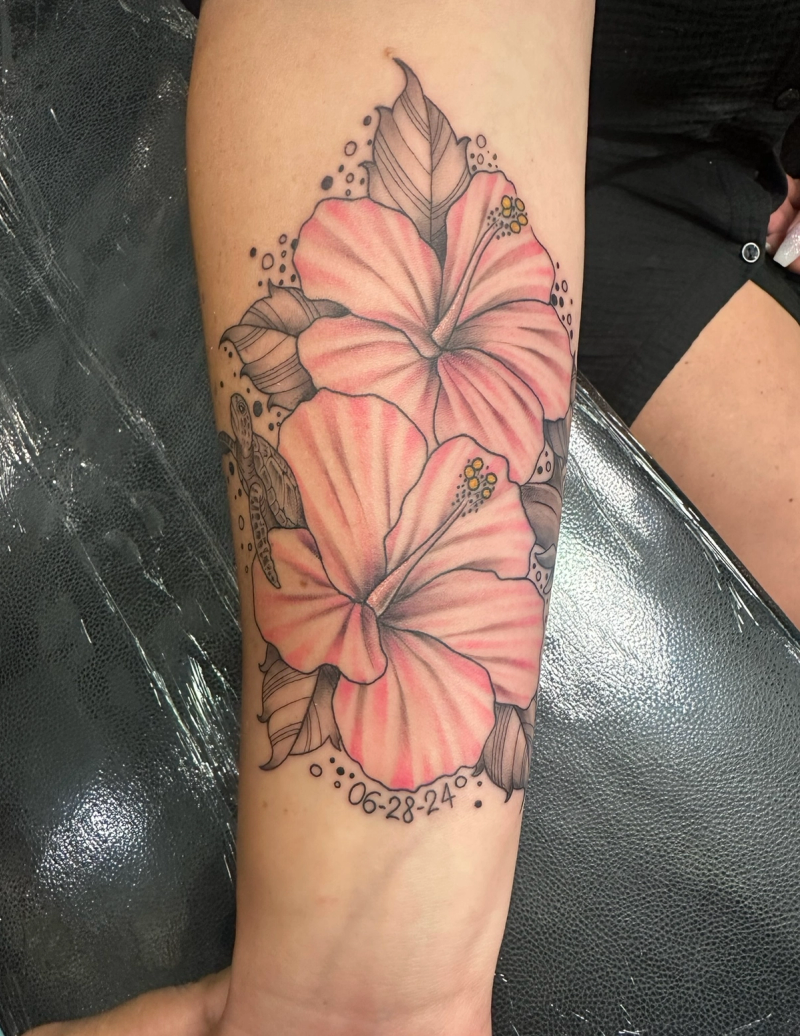 Colorful illustrative hibiscus flower tattoo on forearm