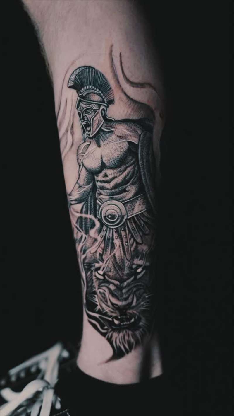 Black and grey realistic Greek warrior and tiger on forearm