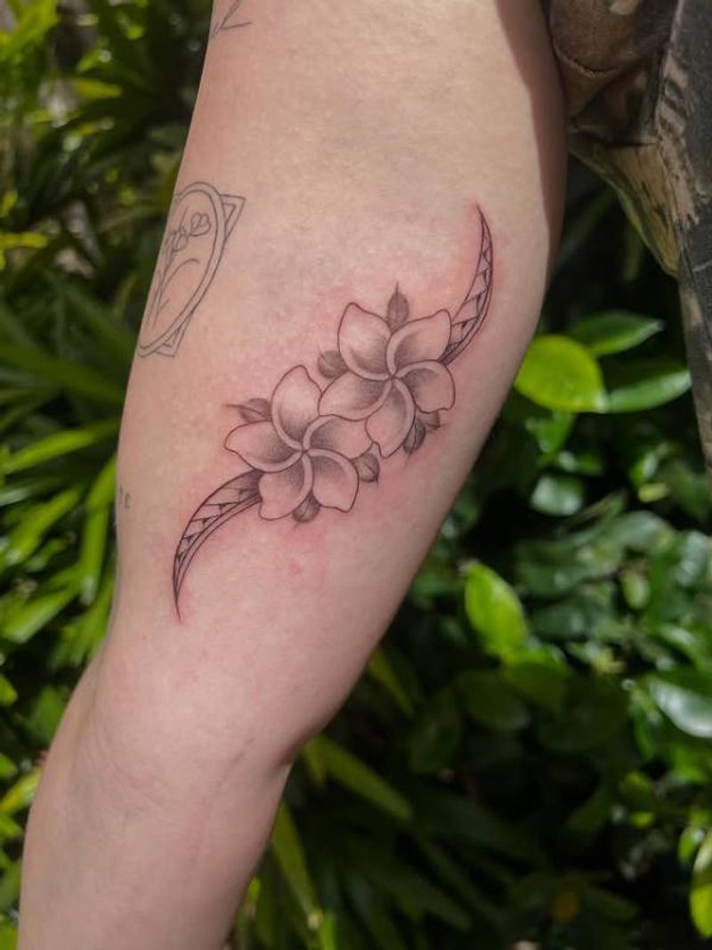Black and grey floral design on upper arm