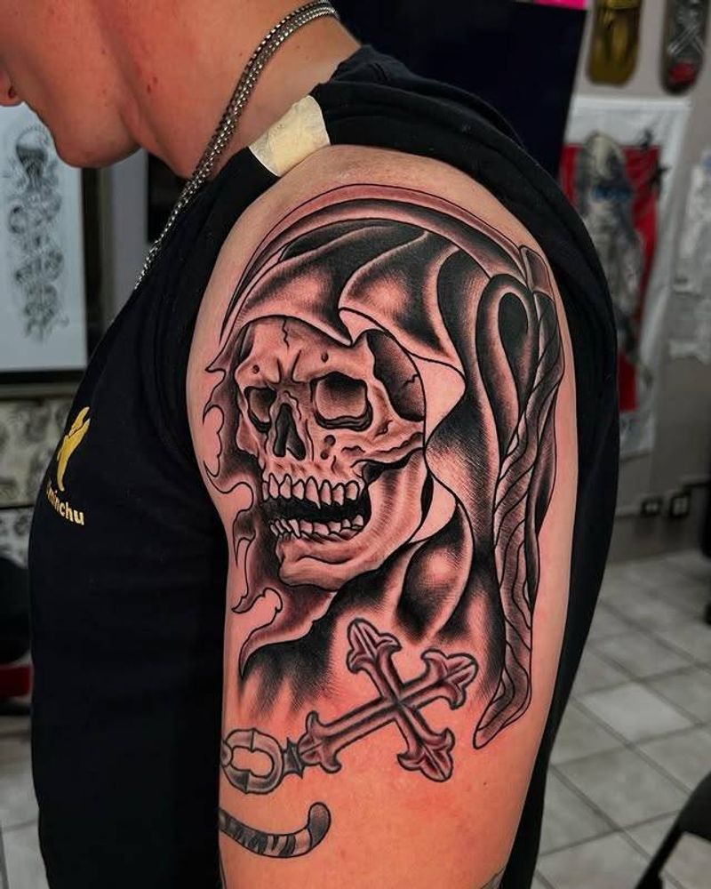 Black and grey grim reaper skull tattoo on upper arm