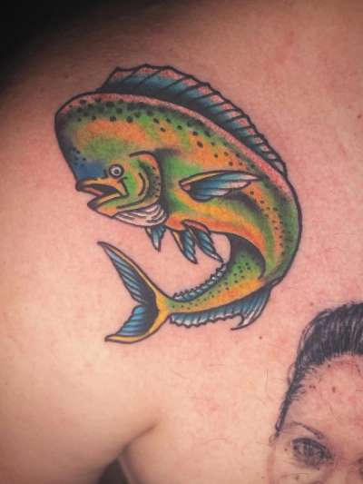 Colorful illustrative fish tattoo on shoulder