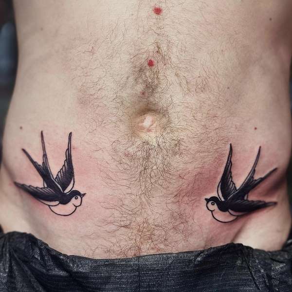 traditional swallow birds tattoo on torso.
