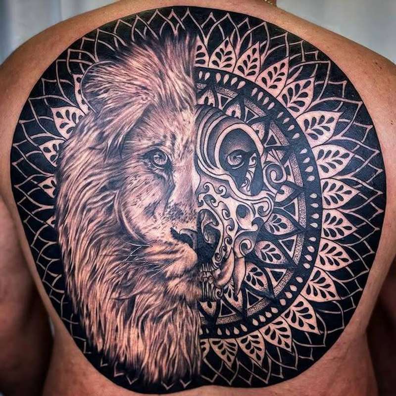 Black and grey lion with geometric pattern tattoo on upper back