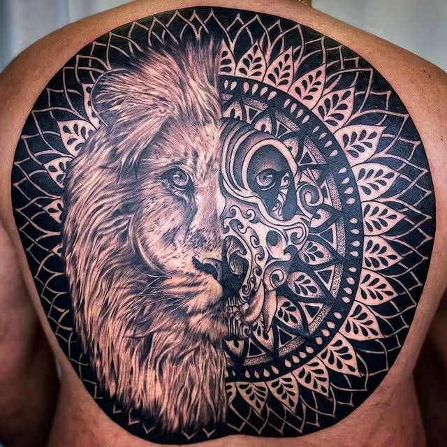 Black and grey lion with geometric pattern tattoo on upper back