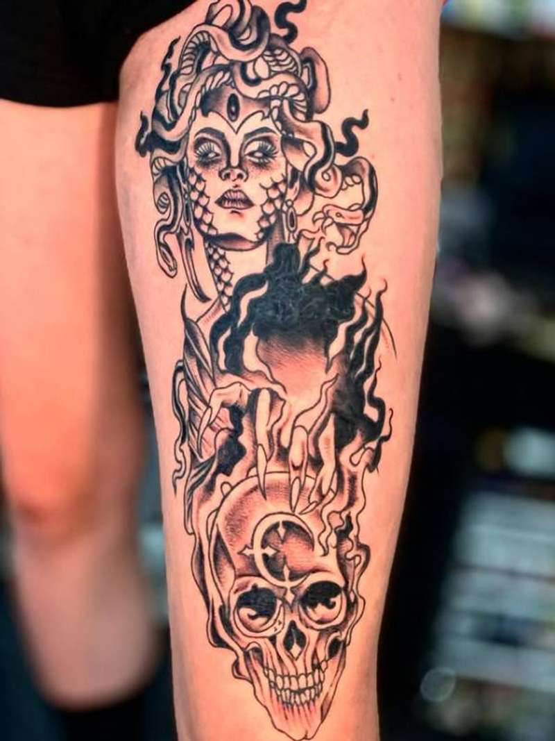 black and grey medusa and skull tattoo on thigh