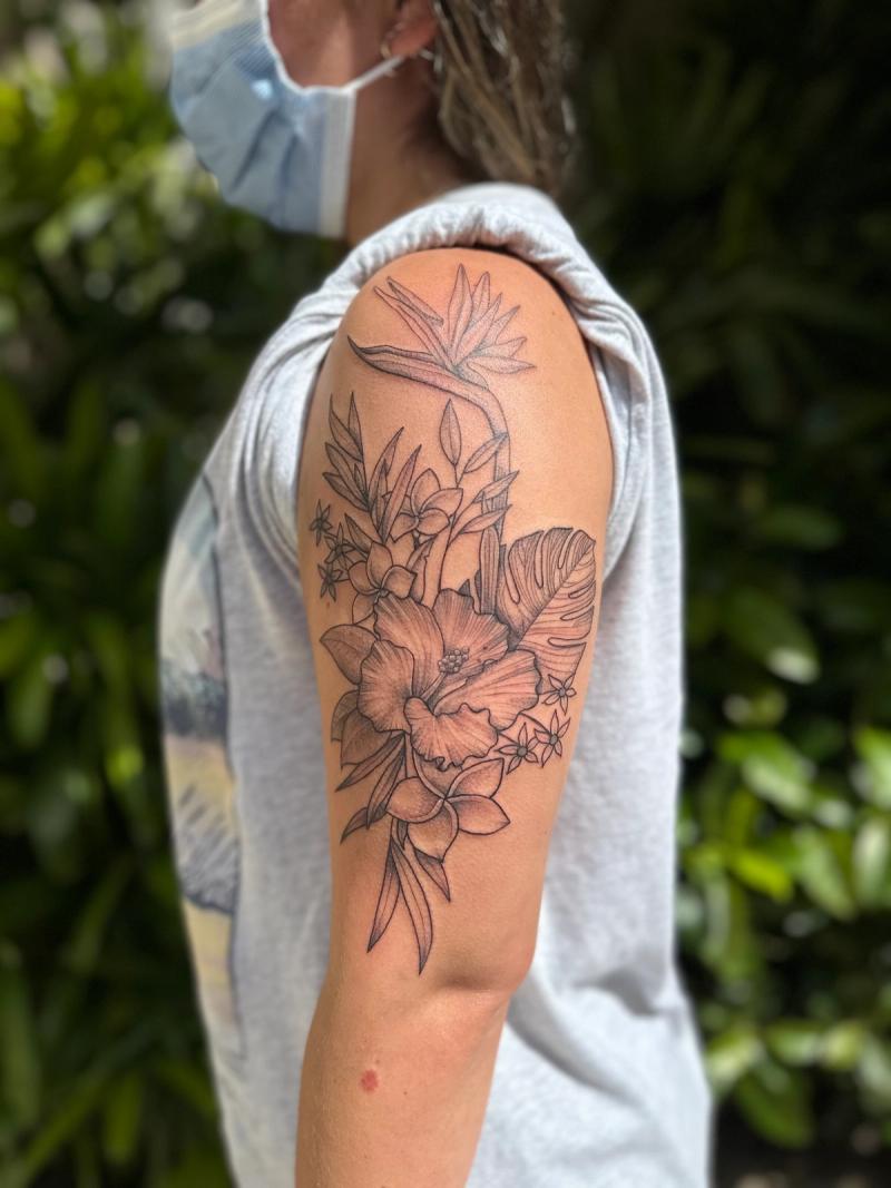 Black and grey fine line floral tattoo on upper arm
