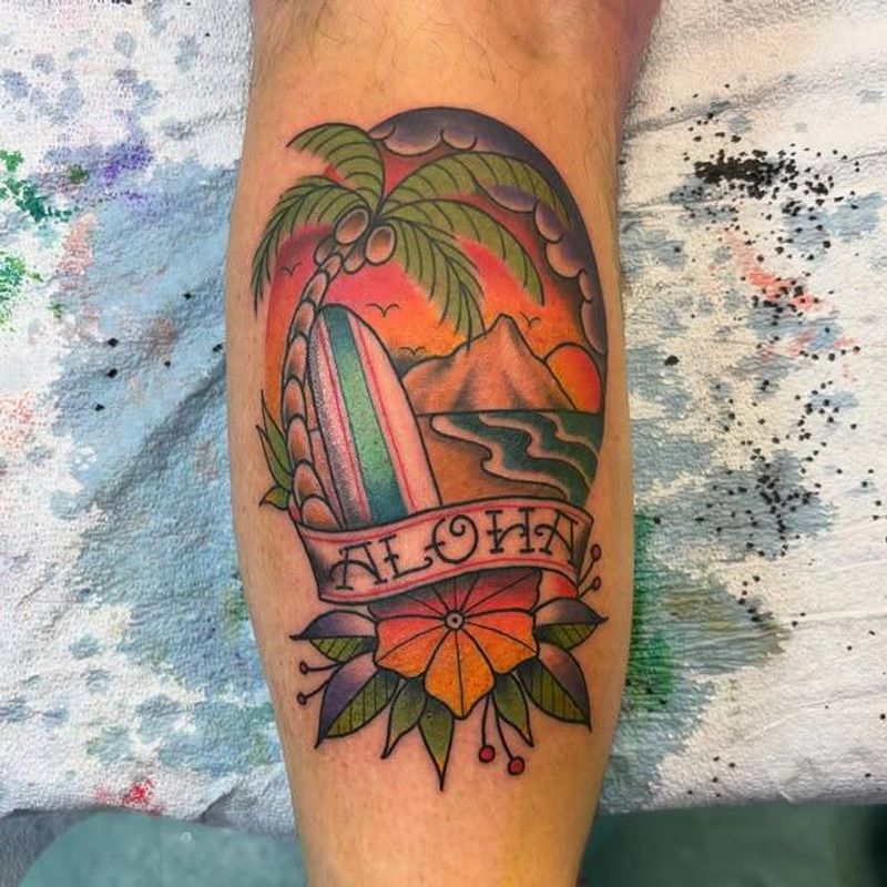 Colorful traditional style tattoo of a Hawaiian sunset on the calf
