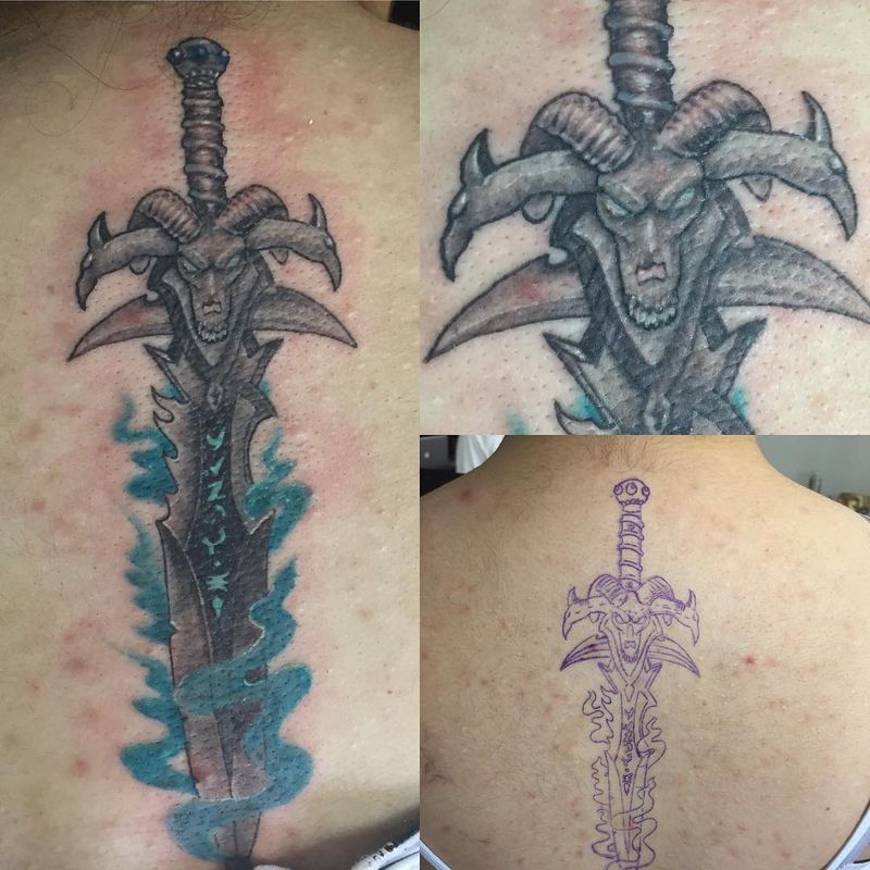 illustrative demon sword tattoo on upper back