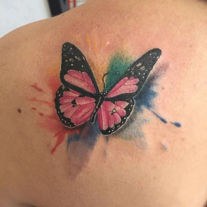 colorful butterfly tattoo on shoulder