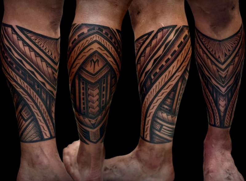 Blackwork tribal design covering entire calf.