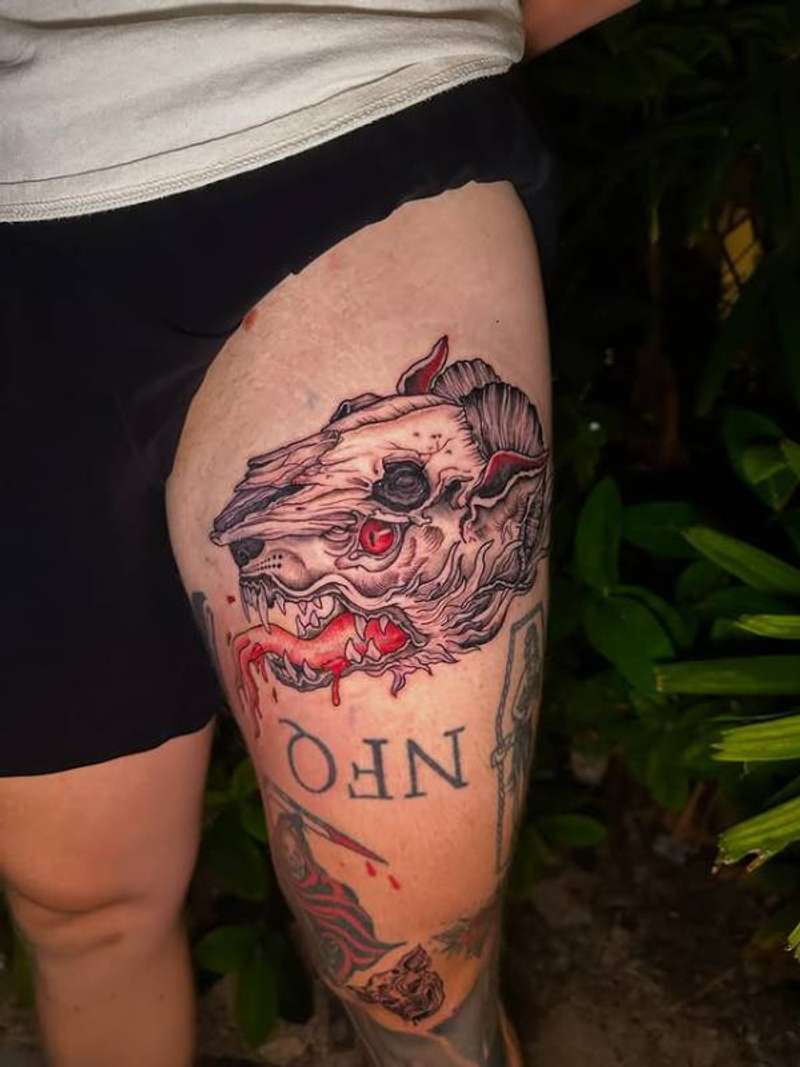 Colorful illustrative animal skull tattoo on thigh