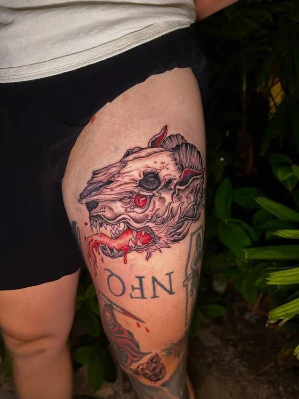 Colorful illustrative animal skull tattoo on thigh