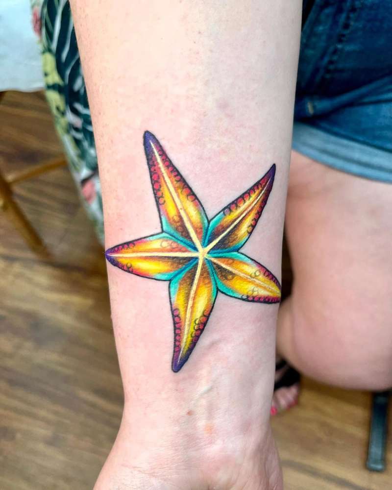 colorful starfish tattoo on forearm