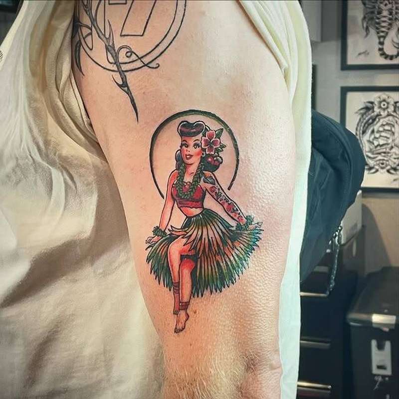 Colorful traditional hula dancer tattoo on upper arm