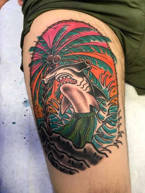 Colorful hammerhead shark and palm tree tattoo on thigh
