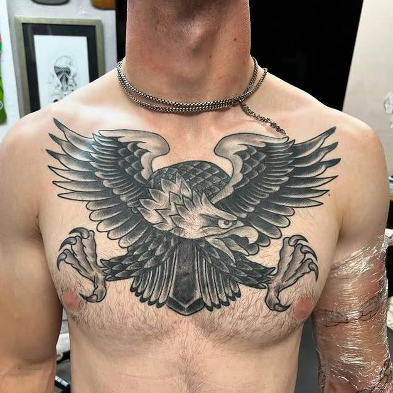 Black and grey traditional eagle tattoo on chest