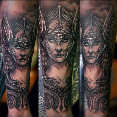 Black and grey realistic Viking warrior portrait tattoo on forearm