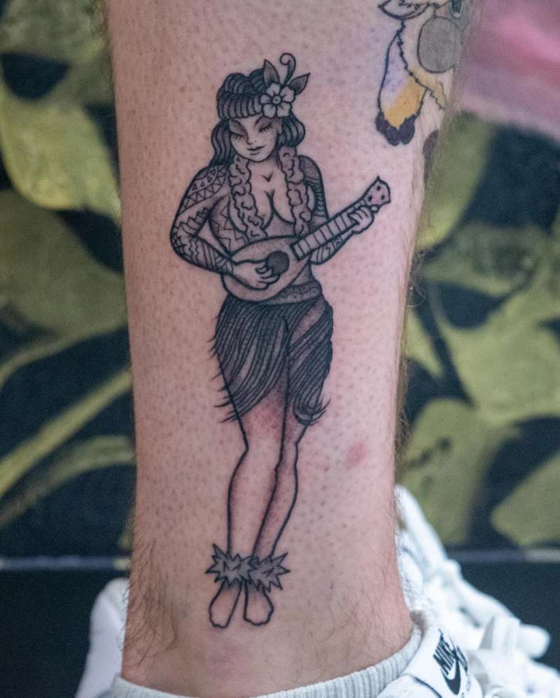 Black and grey hula dancer with ukulele calf tattoo