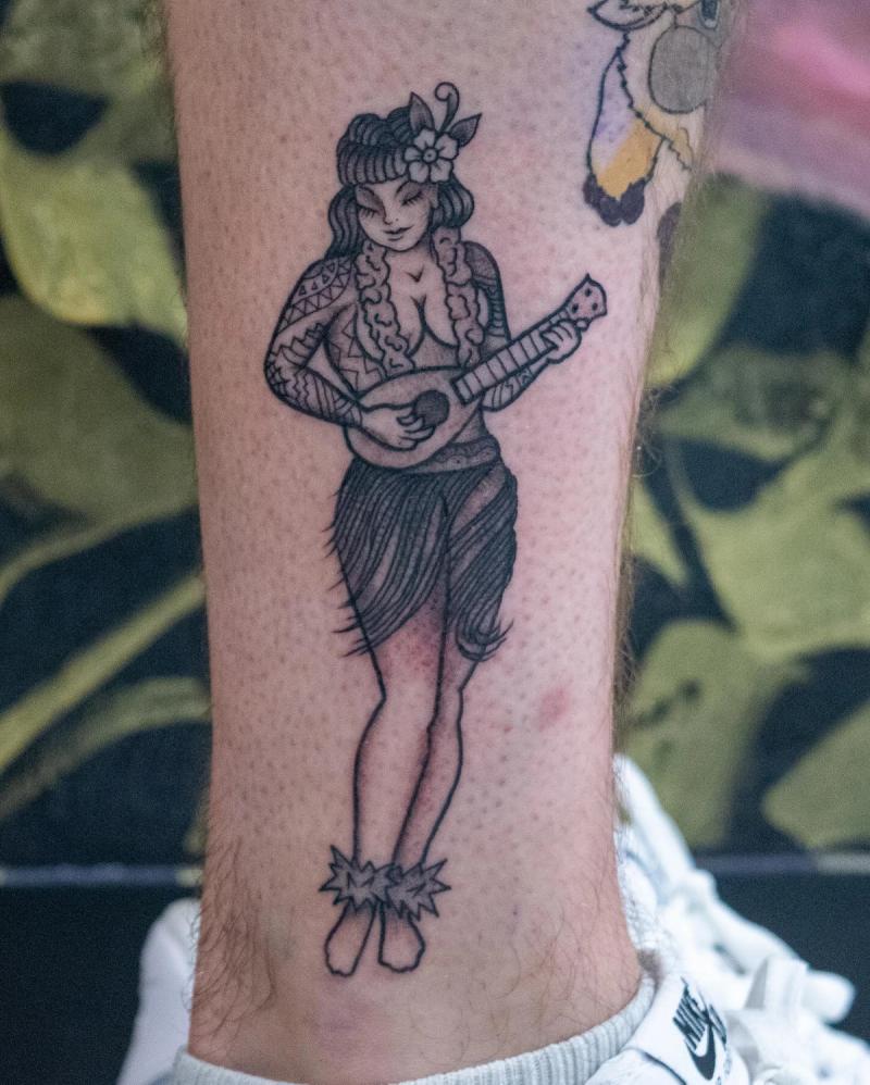 Black and grey hula dancer with ukulele calf tattoo