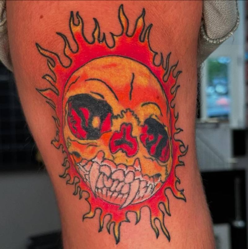 colorful sun skull tattoo on upper arm