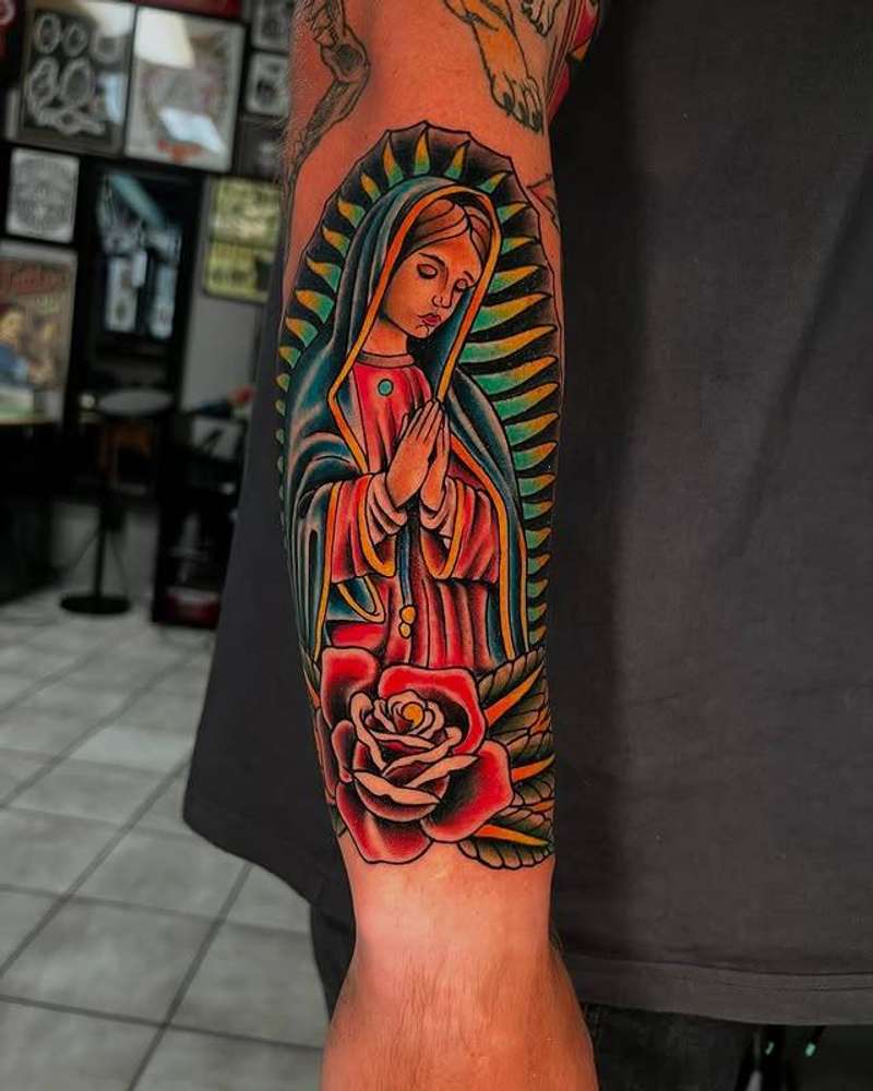 Colorful traditional tattoo of Virgin Mary with a rose on forearm