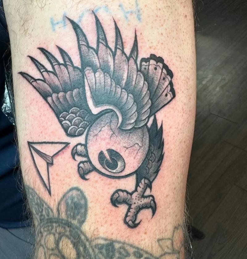 Black and grey neo traditional owl tattoo on upper arm