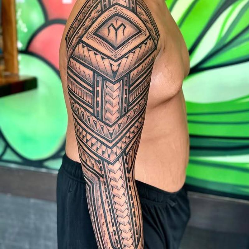 Black and grey geometric tribal sleeve on full arm