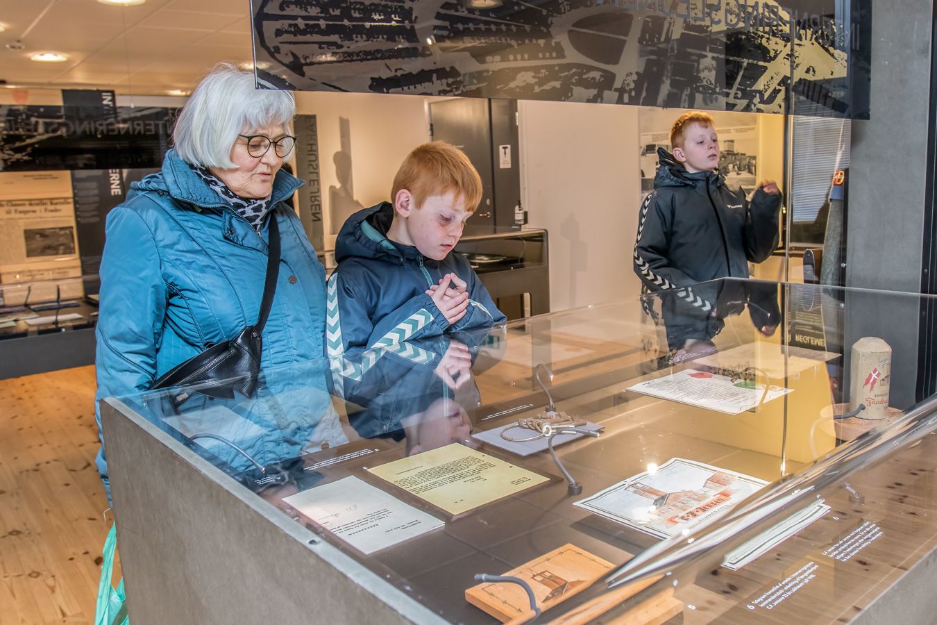 Guests view historical artifacts in an exhibition about the Faarhus camp
